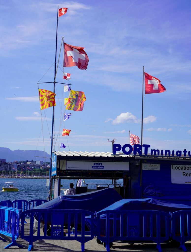 a boat dock with flags flying in the wind